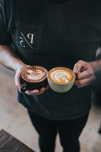 coffee person holding two tea cups point five